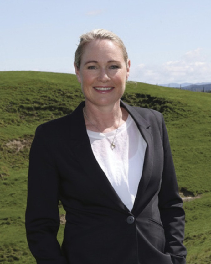 Kimberley Bell standing in green hill country near Wairoa