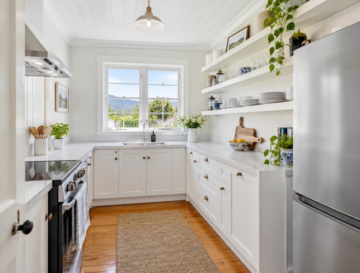 Bright white kitchen with open shelving